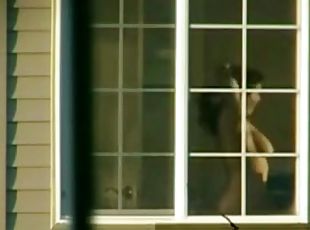 Hot and kinky Asian babe dances for a window voyeur.